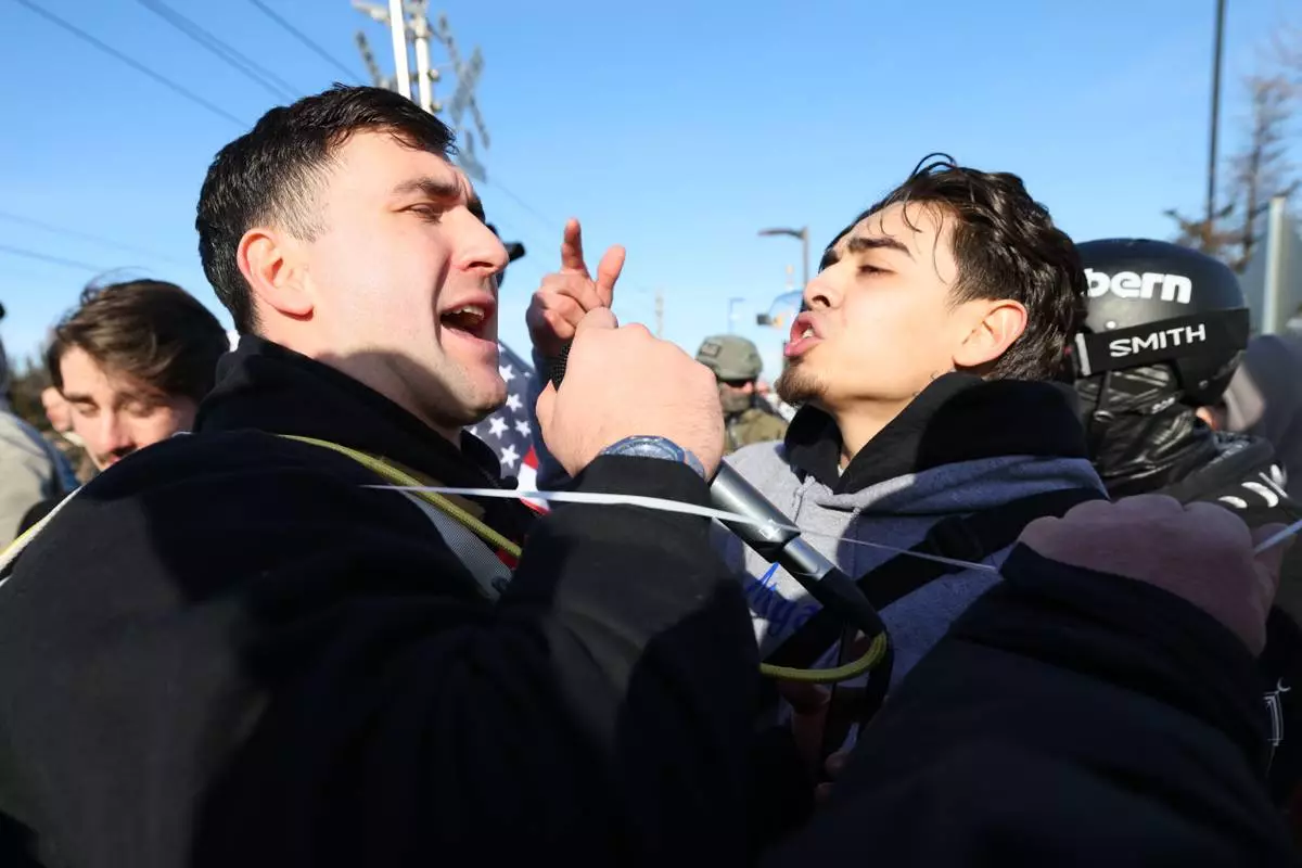 A supporter of United States Immigration and Customs Enforcement argues with a counter protester outside the Bishop Henry Whipple Federal Building in Minneapolis, Friday, Jan. 9, 2026. (AP Photo/Adam Bettcher)