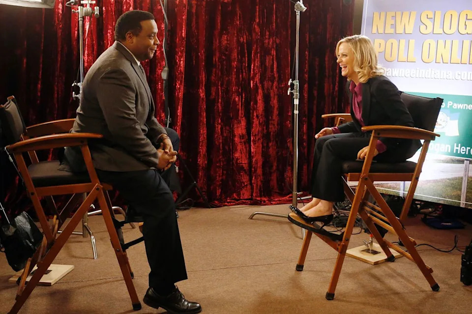 Jordin Althaus/NBCU via getty Jay Jackson as Perd Hapley and Amy Poehler as Leslie Knope on 'Parks and Recreation'