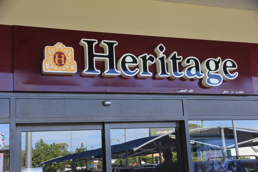 A sign above a door saying Heritage Bank.