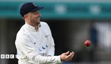Ollie Robinson smiles as he tosses the ball to a team-mate