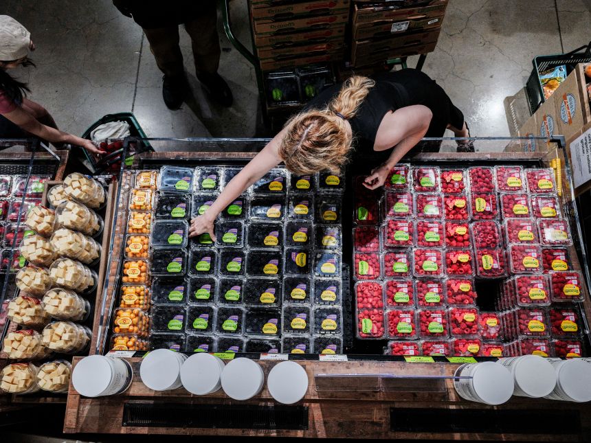 People shop for groceries at a store in New York on July 15.