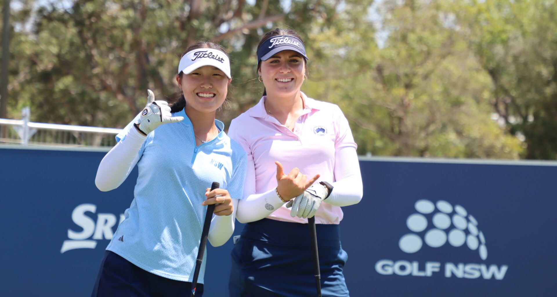 A picture of Camilla Kim and Lara Thomsen holding their hands up smiling