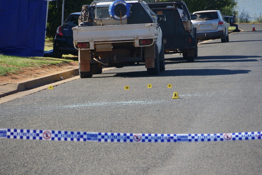 Cars at crime scene, shops closed, personnel on the ground for search