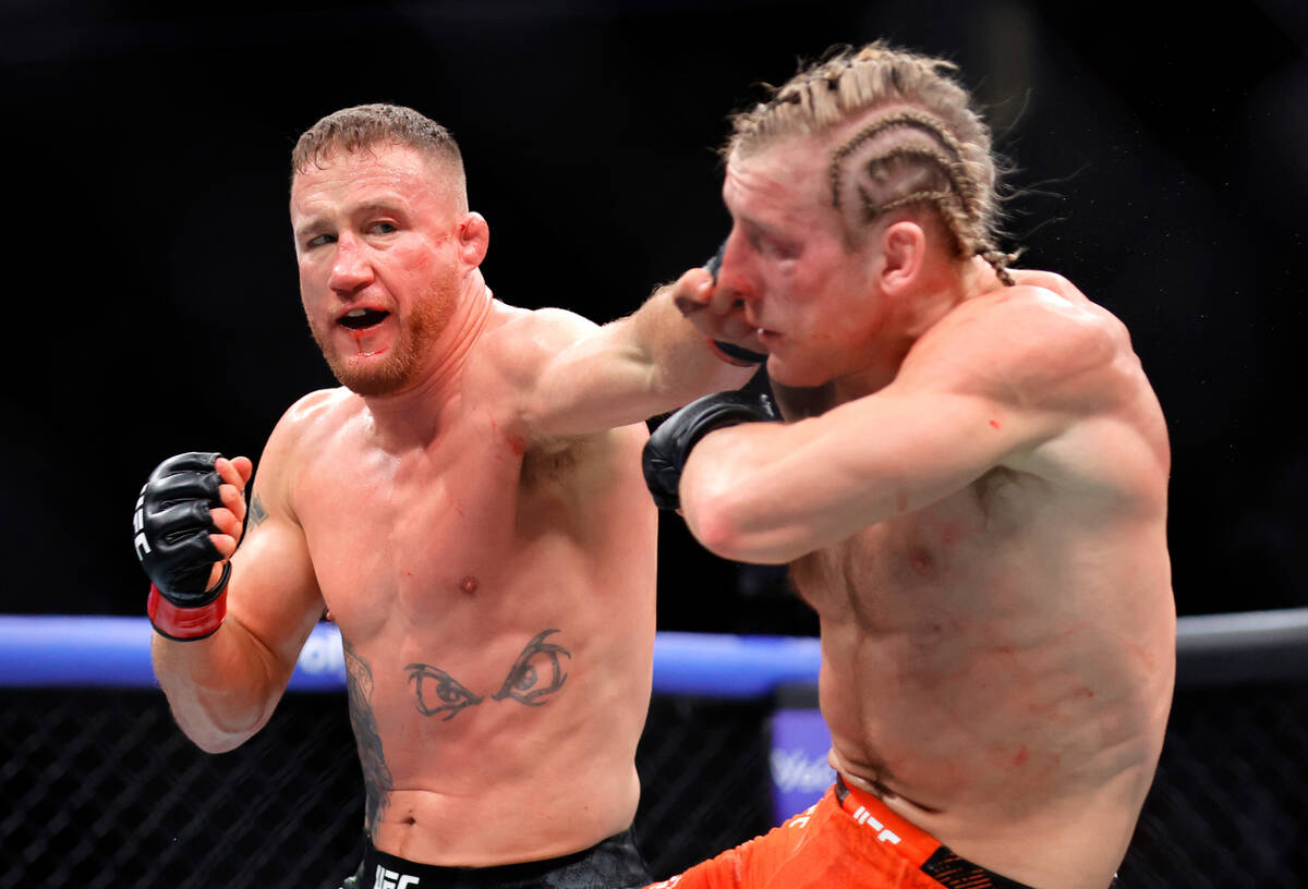 Justin Gaethje, left, punches Paddy Pimblett in an interim lightweight title fightduring the UF ...