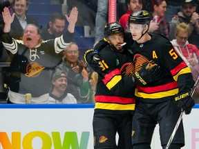 Evander Kane is congratulated by Tyler Myers after scoring a goal against the Washington Capitals during the first period at Rogers Arena on Wednesday night