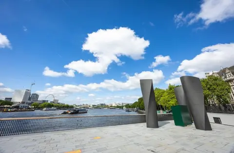 Tideway Concrete riverside with the London Eye - a large ferris wheel - in view