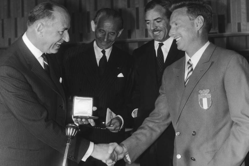 Eugenio Monti accepts the Pierre de Coubertin Fair Play Trophy