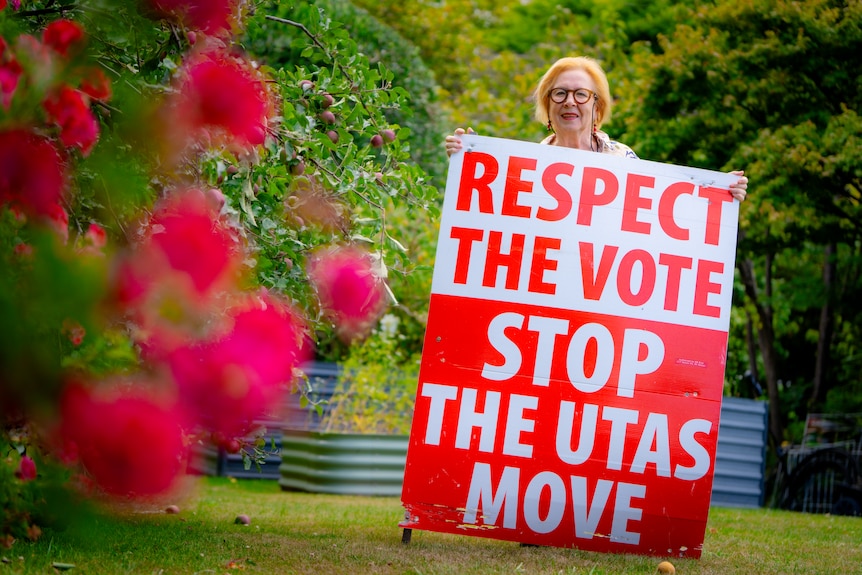 A sign with the words 'respect the vote, stop the UTAS move' pictured in a suburban yard.