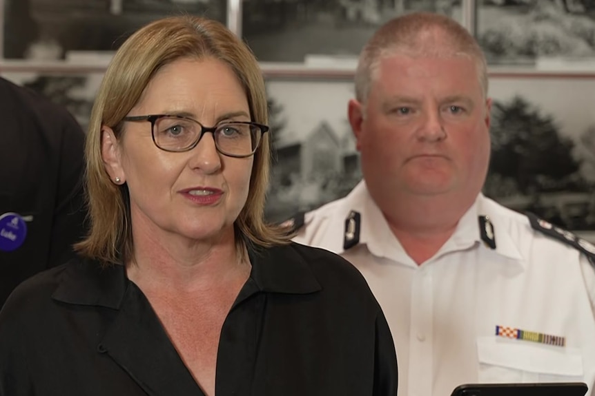 Premier Jacinta Allan speaks at a press conference, wearing glasses and a black top