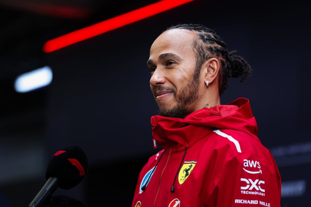 Lewis Hamilton talks into a mic