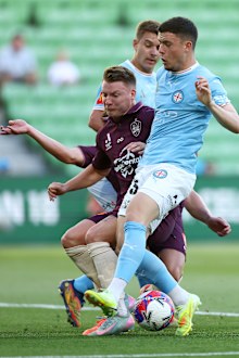 Melbourne City's Medin Memeti and Brisbane Roar's James McGarry contest the ball during their round 20 A-League Men match.