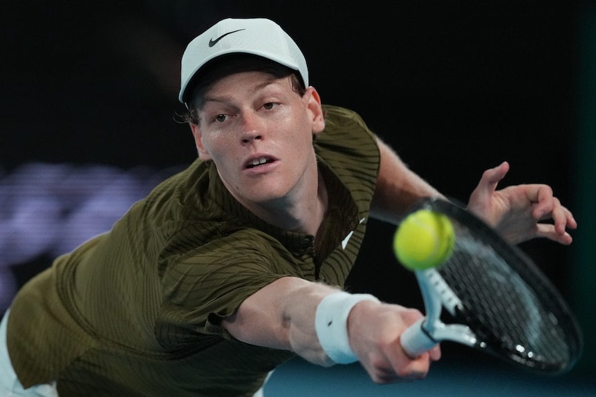 Jannik Sinner plays a backhand at the Australian Open.