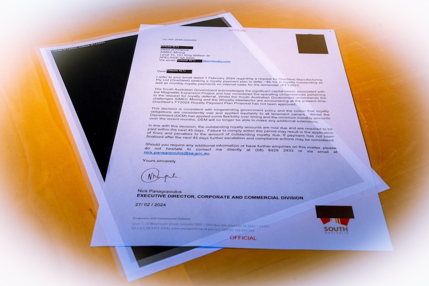 A letter from SA government to SIMEC mining about overdue royalties on top of other black redacted pages