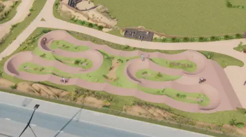 Government of Jersey Aerial view of a digitally created pump track featuring a series of smooth, looping dirt paths with raised berms and dips arranged in a compact, winding layout. The track is surrounded by green grass and landscaped areas, with a paved road visible at the bottom edge.
