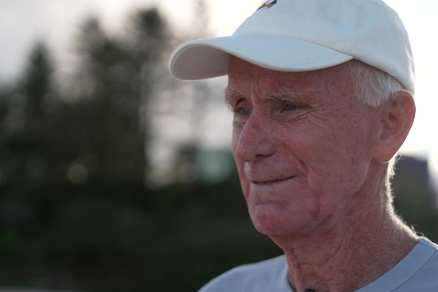 Man up close wearing hat.