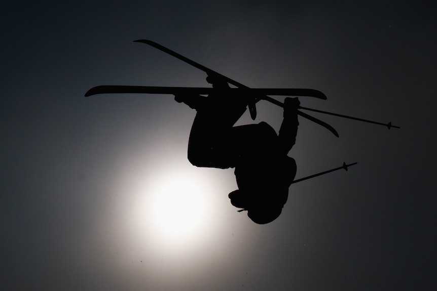 Indra Brown completes a trick in silhouette