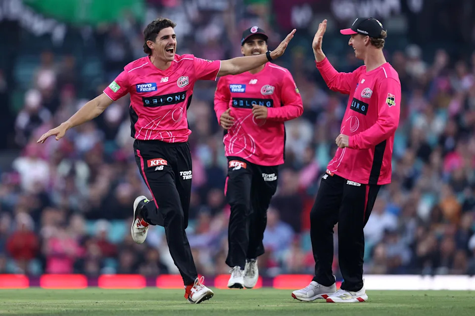 Seen here, Sean Abbott celebrates with Sydney Sixers teammates in the BBL.