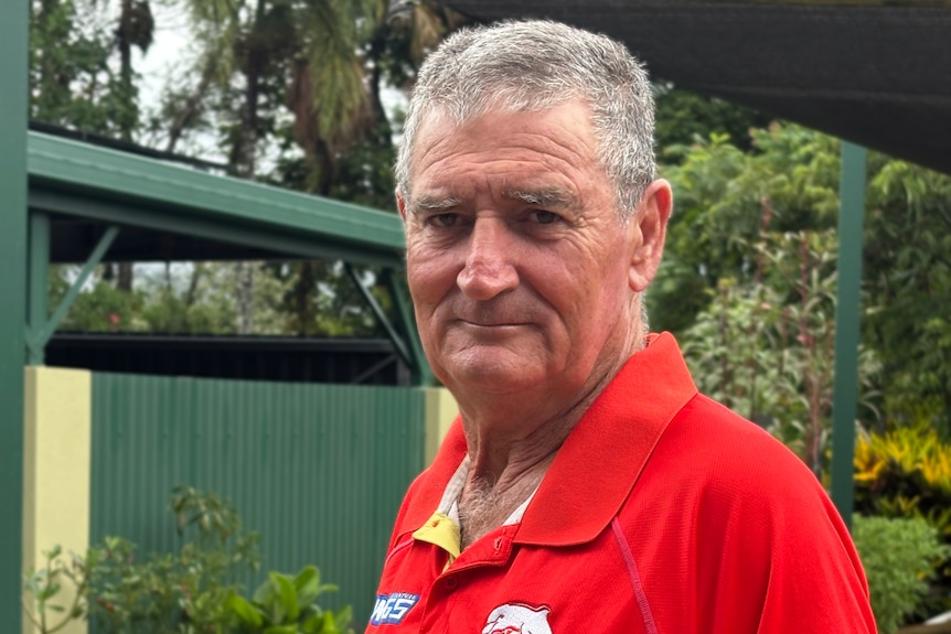 David darrington in a red shirt looks at the camera