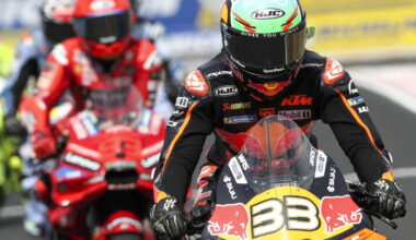 Brad Binder leads Marc Marquez out of the pits during MotoGP 2025.