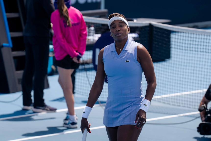 A woman on a blue tennis court