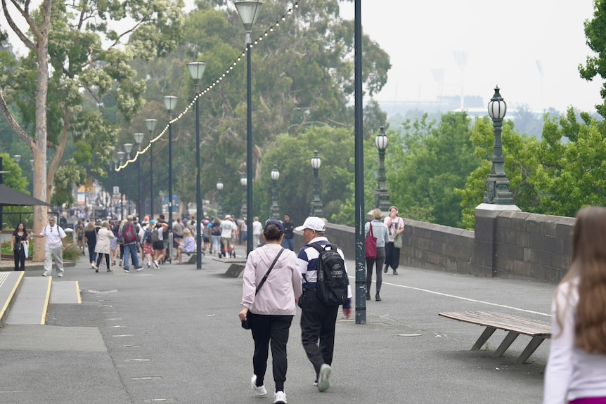 Groups of people walking thorugh melbournes parks