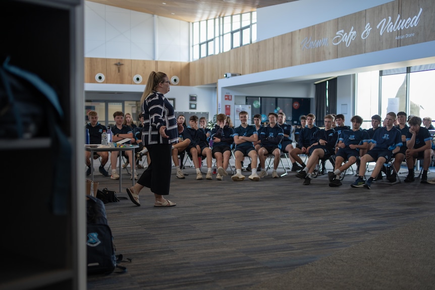 Alyssia Kennedy  in front of students.