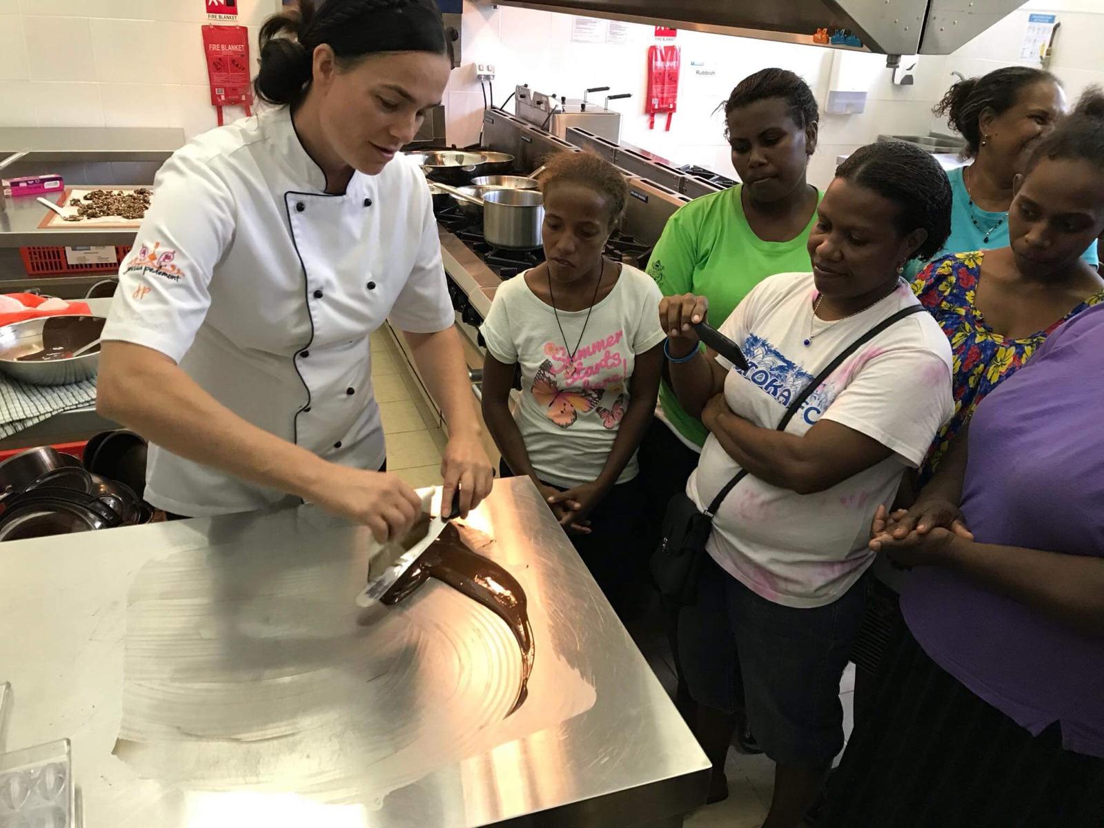 a women teaching people how to cook with chocolate