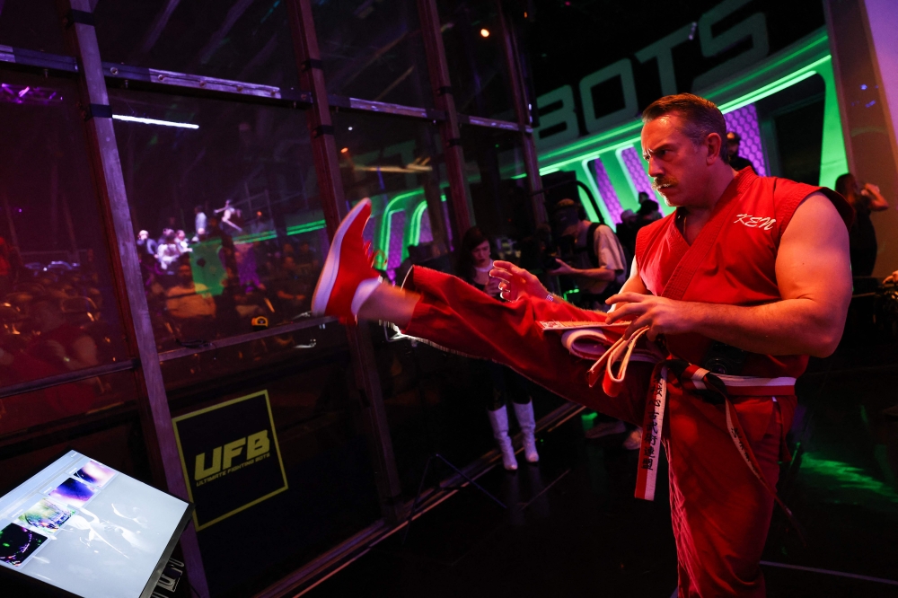 Fighting robot pilot ‘Master Ken’ warms up his kicks before the Ultimate Fighting Bots (UFB) competition at the BattleBots Arena. — AFP pic 