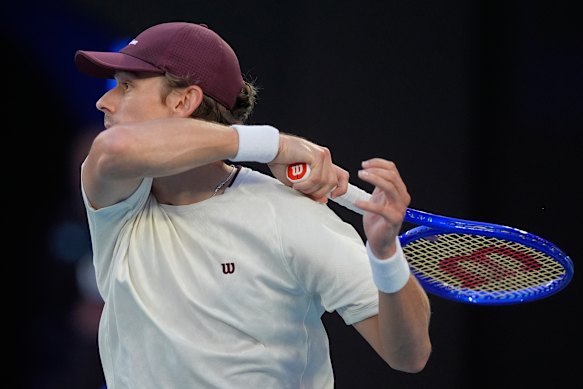 De Minaur crunches a forehand return of serve.