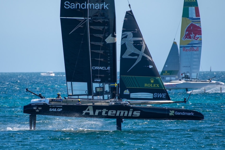 A boat rising out of the water during racing.