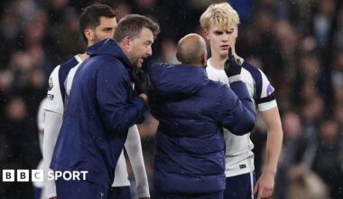Lucas Bergvall of Tottenham Hotspur is treated by medical staff before he goes off with a concussion injury