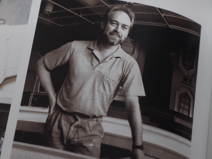 A black in white photo of a man in a workshop