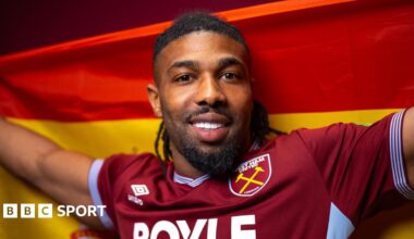 Adama Traore holding a Spanish flag behind his head
