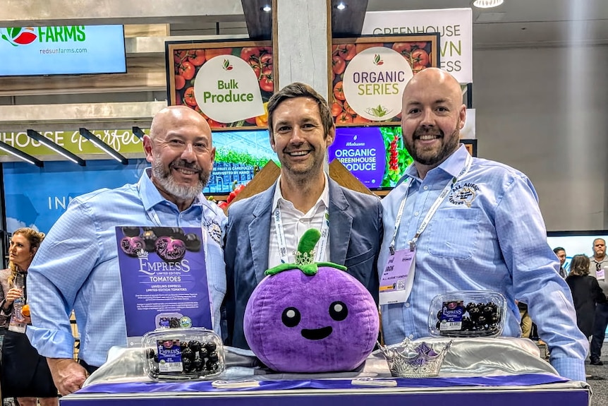 Several people at a trade stall.