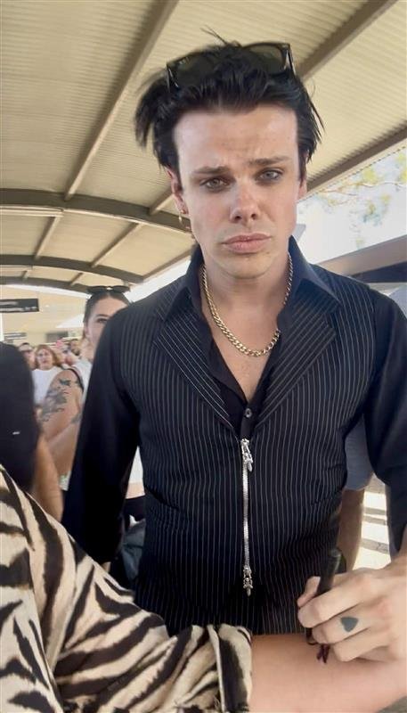 Melanie was able to catch the rockstar outside the airport, where he signed her arm for her. 