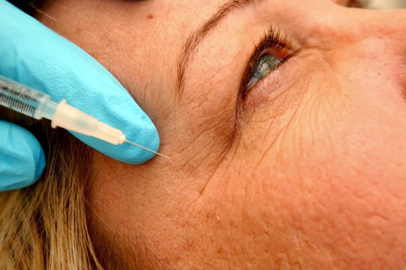 Close-up of woman getting an injection of Botox