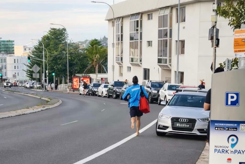Mr Doolan running barefoot along a street at Bondi towards the scene of a terror attack.