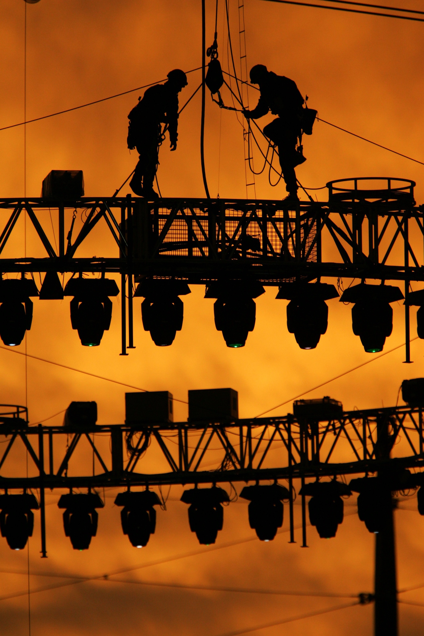 Orange you glad it's not you: techs set up the lighting rig for the Melbourne Commonwealth Games at the MCG in 2006