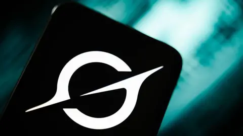 Getty Images A black and white logo on what looks like a mobile phone.