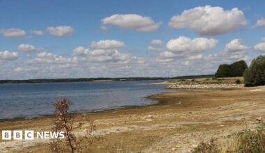 A large reservoir of water with long, dry banks around the edges.