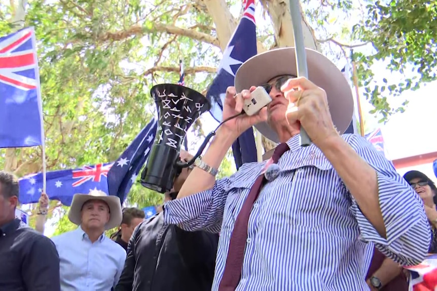 Bob Katter speaks into a megaphone.