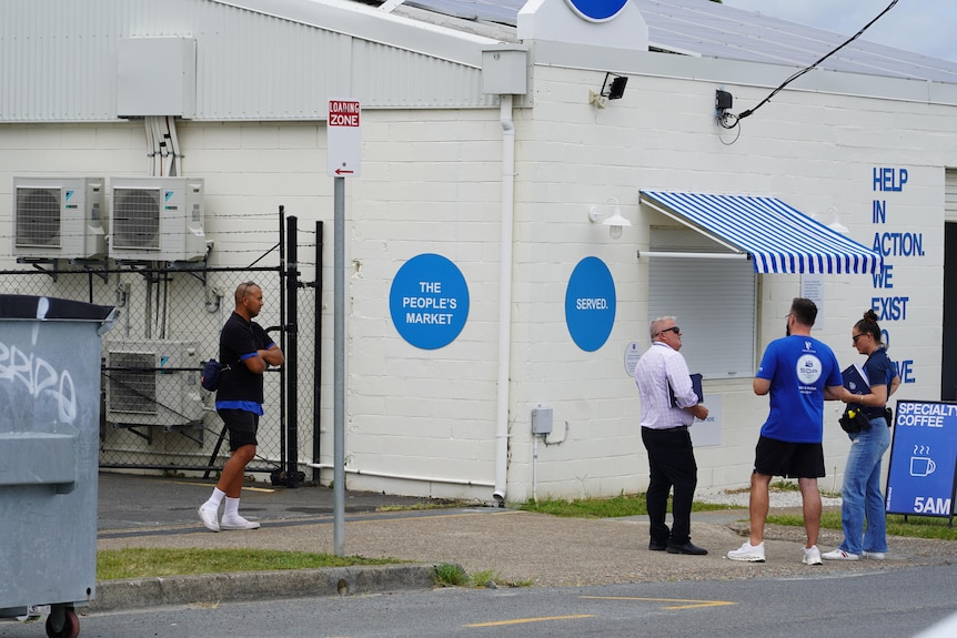 Plain-clothes police out the front of the Serving Our People buildings.