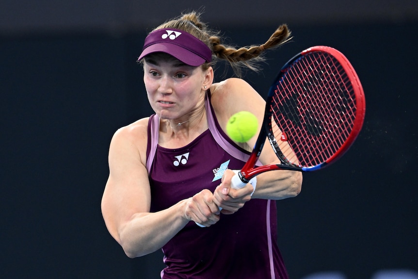 Elena Rybakina hitting a tennis ball with her racquet