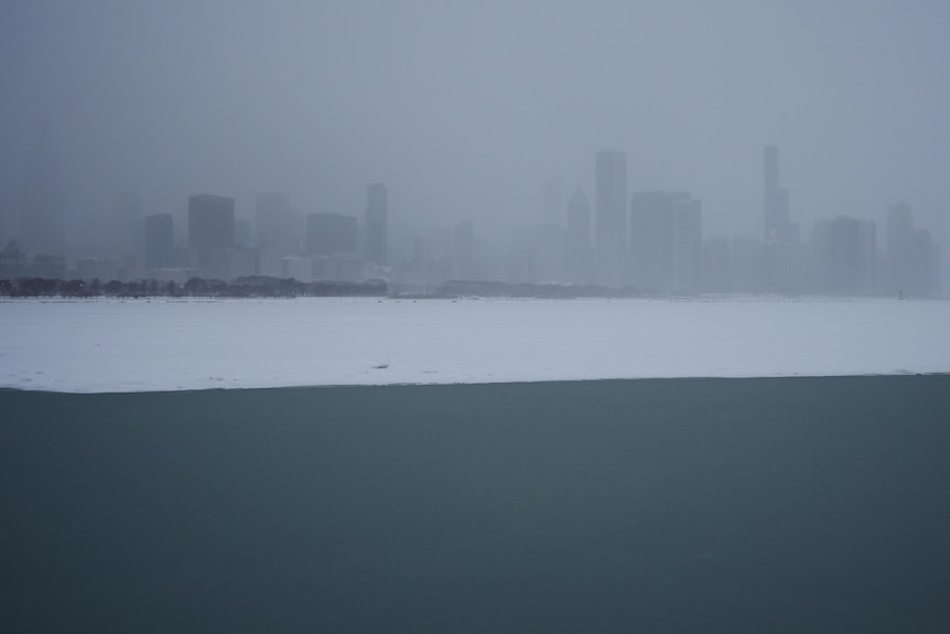 Lake Michigan covered with snow with Chicago in the background.