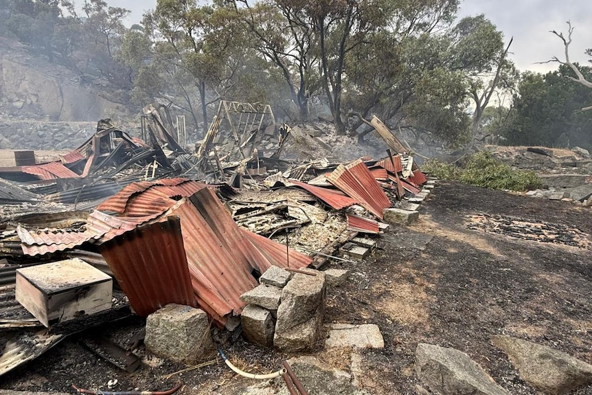 a damaged brick tin and wood structure after a fire