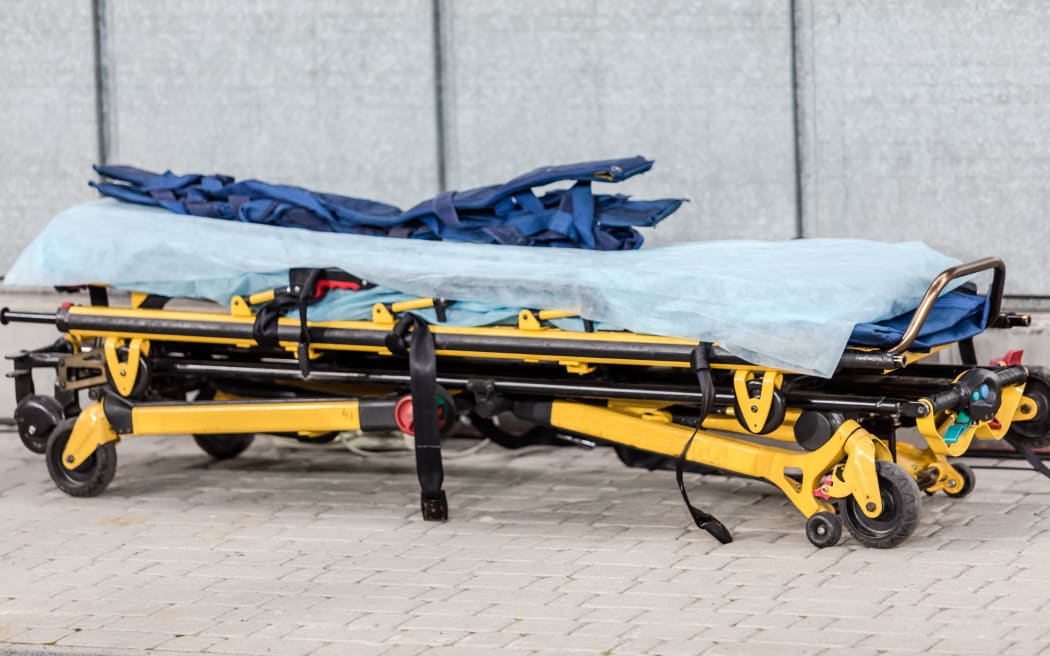 Paramedic ambulance equipment at football stadium for help.