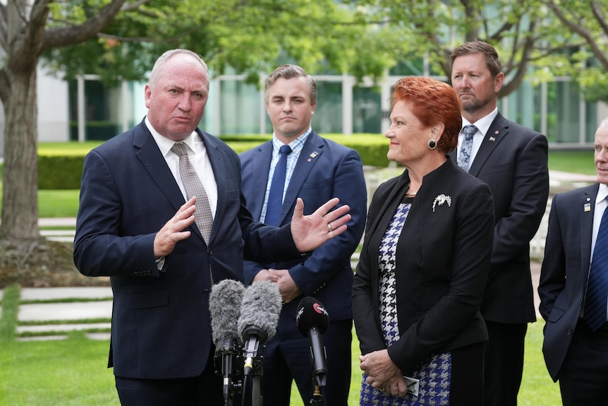 Barnaby Joyce with Pauline Hanson and One Nation members stand at a press conference