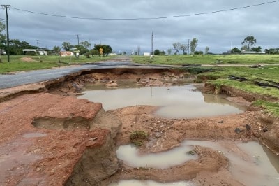 A huge wash out of a bitumen road due to flood damage.
