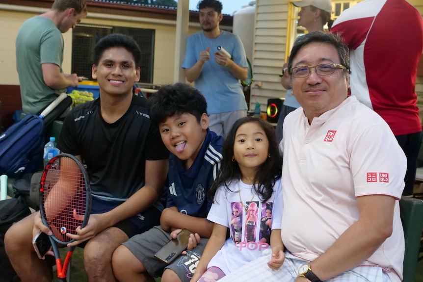 a filipino family, a young man, young boy, little girl, and older man