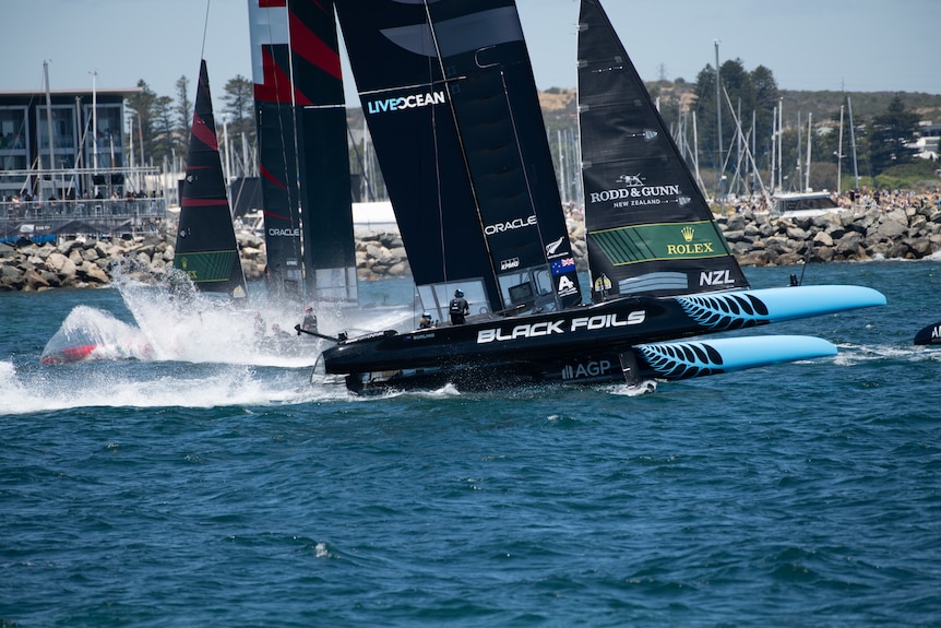 Boats racing with spray shooting up from the water.